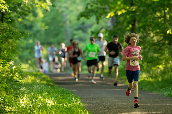Runners racing along the shores of Lake Galena during the BCRR Twilight 5K